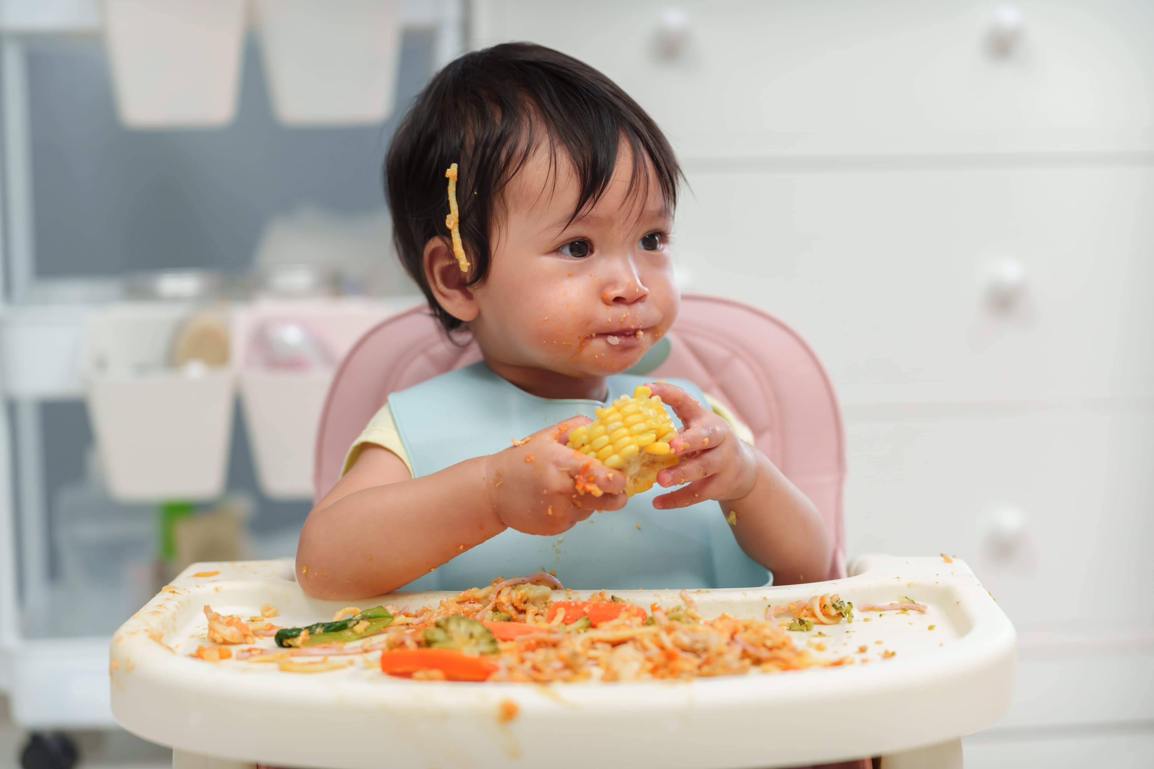 Infant making a mess doing baby-led weaning